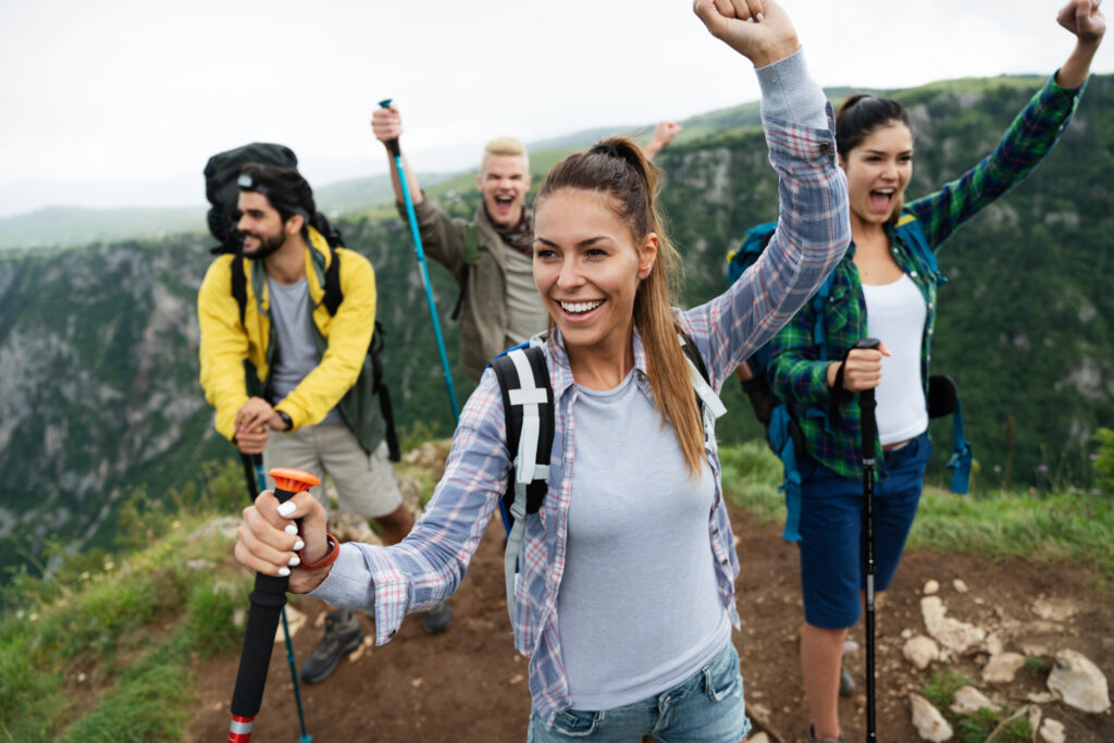 group of fit healthy friends trekking in the mountains
